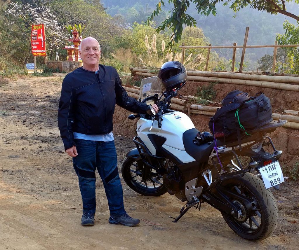Joe Nattress with motorcycle in the mountains of Chiang Mai, Thailand.